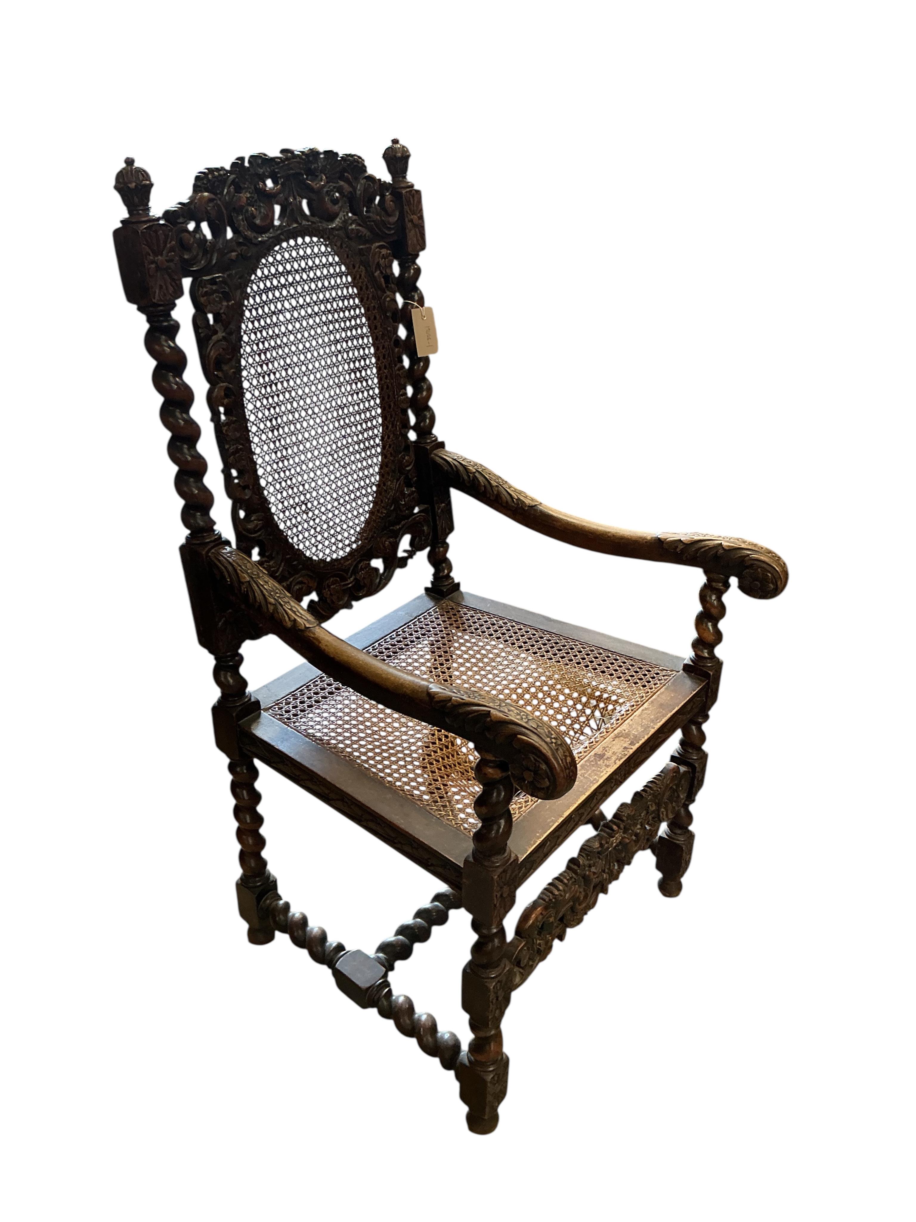 A Carolean style caned carved walnut elbow chair, width 61cm, depth 51cm, height 114cm